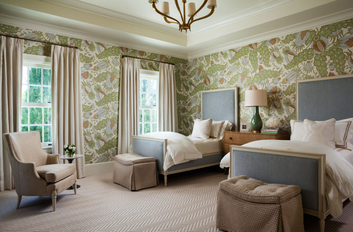 bedroom with white, blue, and green wallpaper and blue twin beds