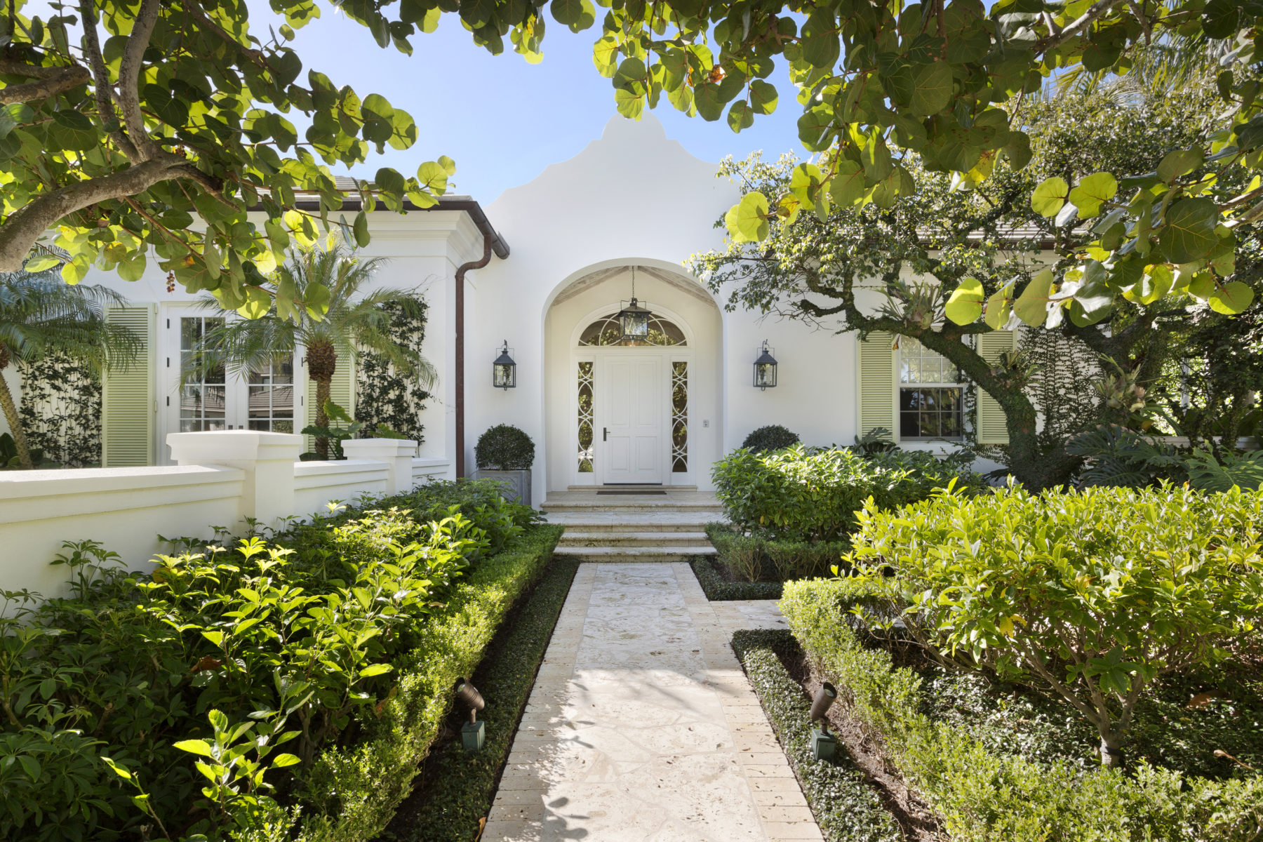image of North End Bermudian front of white one story house and tropical landscaping