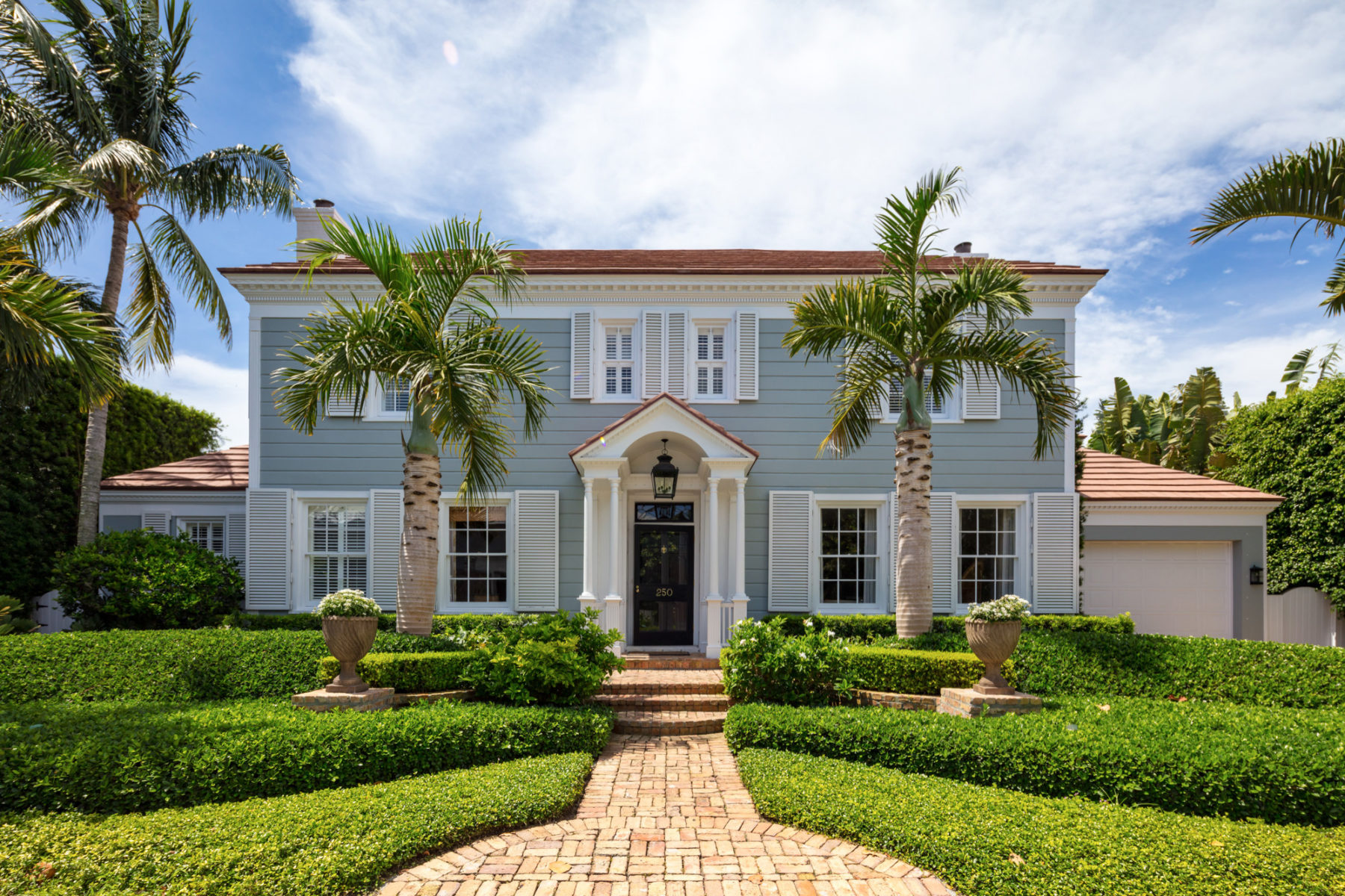 image of Coastal Colonial front of two story home with palms