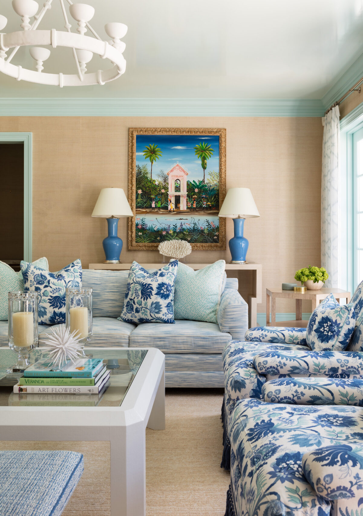 living room with beige walls, white and blue furniture, and aqua wall trim.