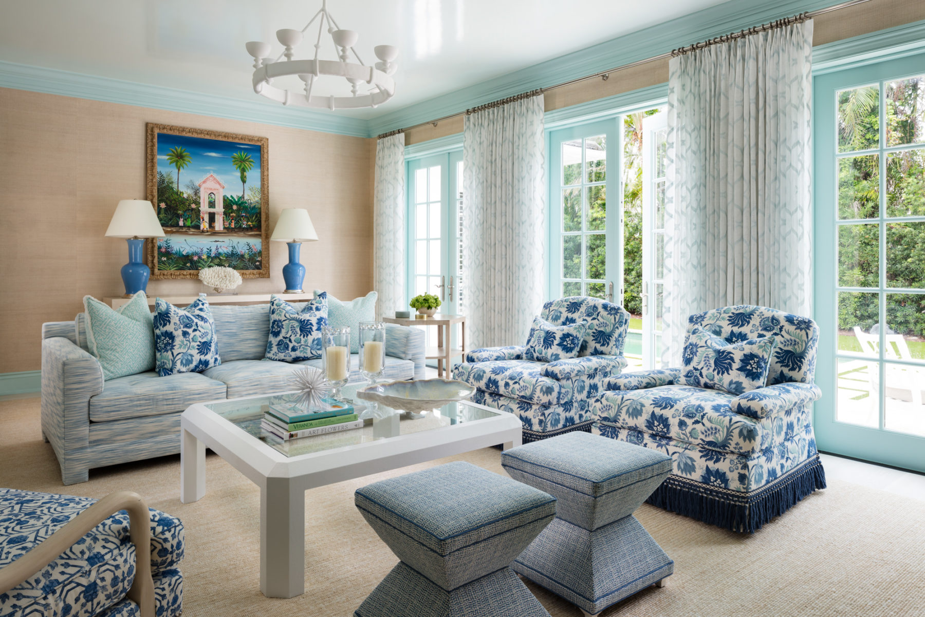 image of Seaside Vacation Home living room with neutral walls, blue trim, and blue patterned seating