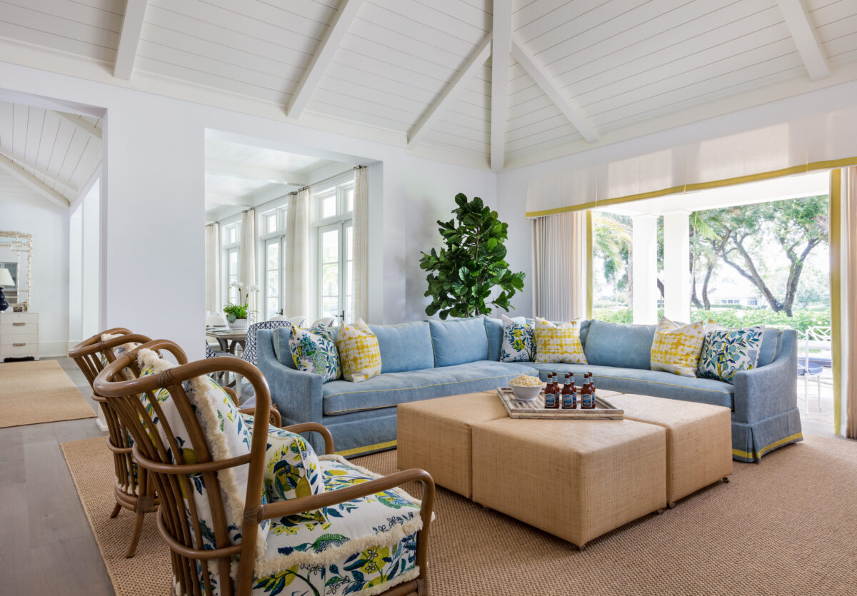 living room with blue sofas, and green and yellow accents