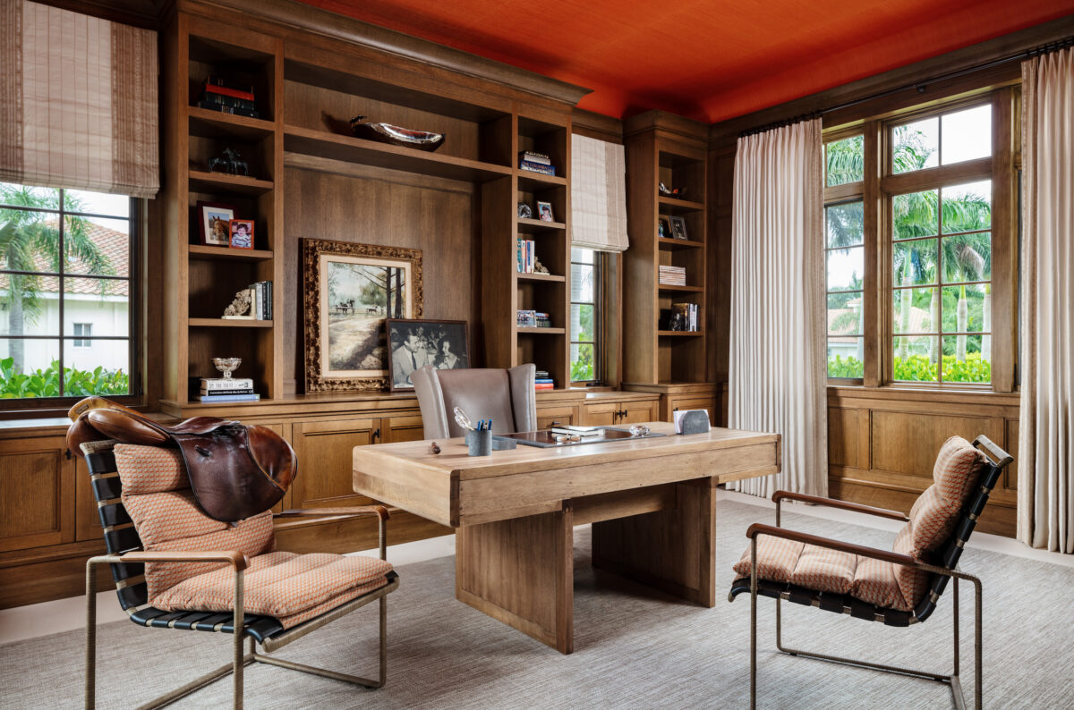 office with dark wood built-in cabinets, a wood desk, and orange ceiling