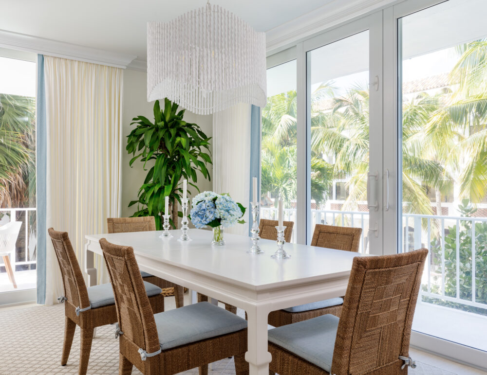 dining area with rectangular dining table, chairs, a tree in the corner, and a wall of windows