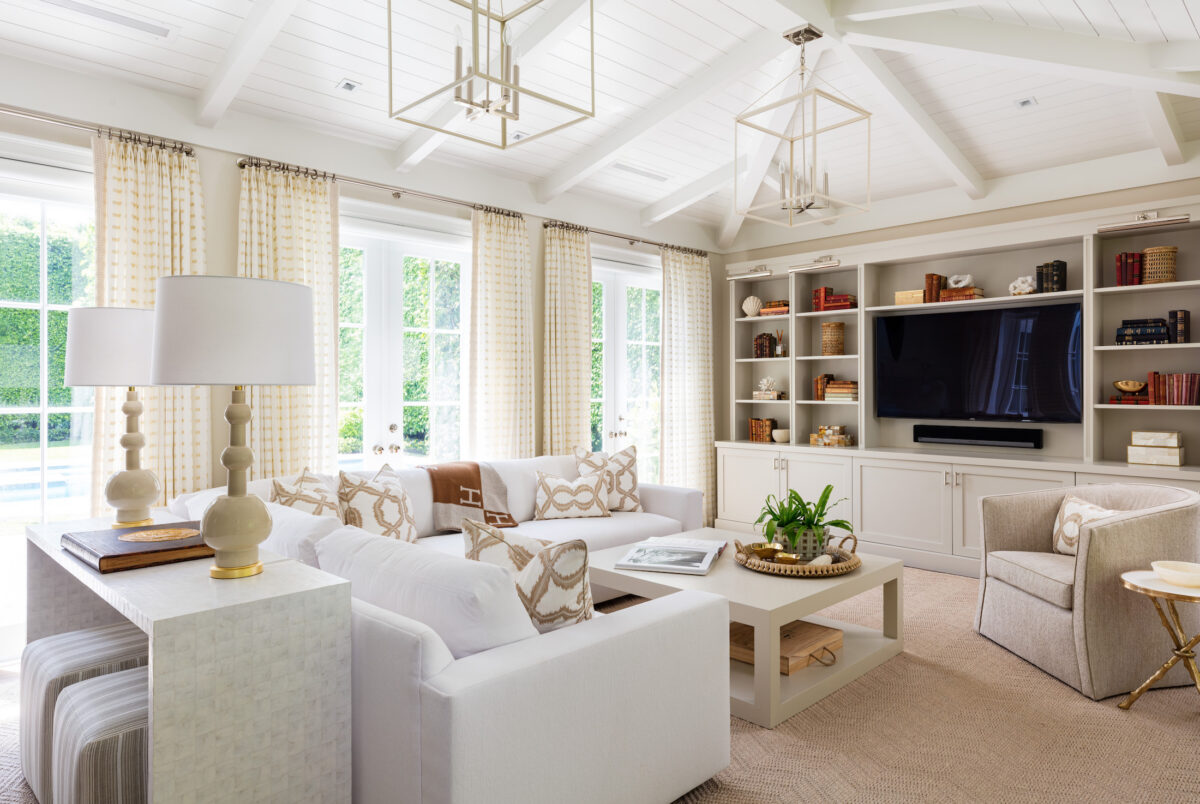 living room with neutral furnishings, a vaulted ceiling, and french doors