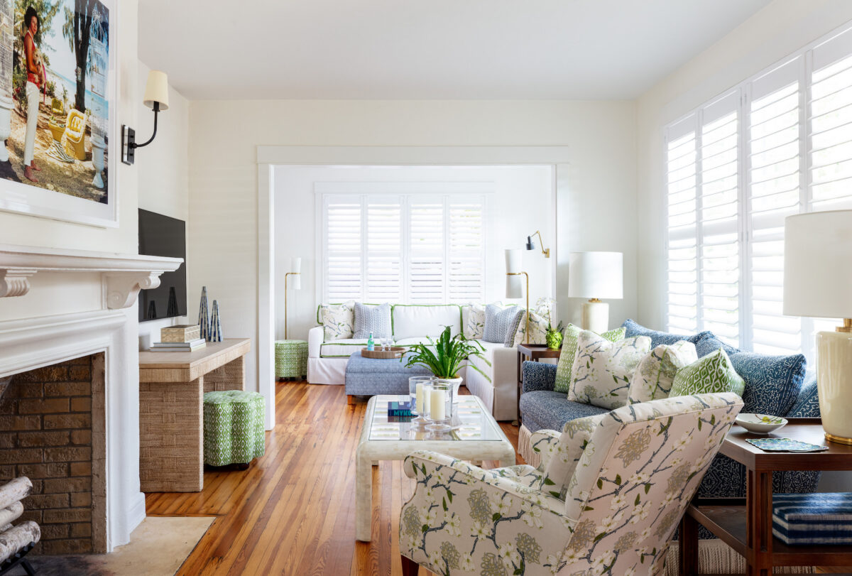 living room with fireplace, blue sofa, and cream and green accents
