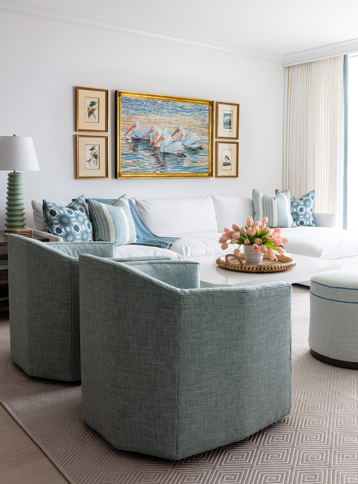 living room with white sofa, wall art above sofa, and teal and blue accents