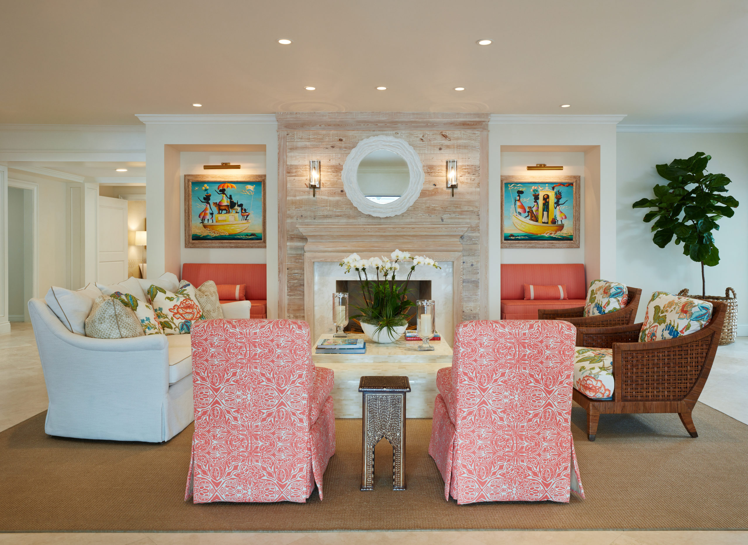 image of sitting room in private club with coral accent chairs and Pecky cypress fireplace