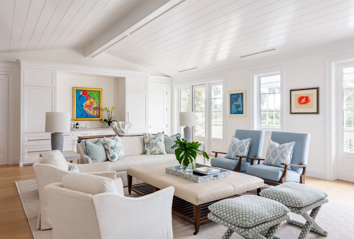 living room with white and blue accents and multicolored wall art