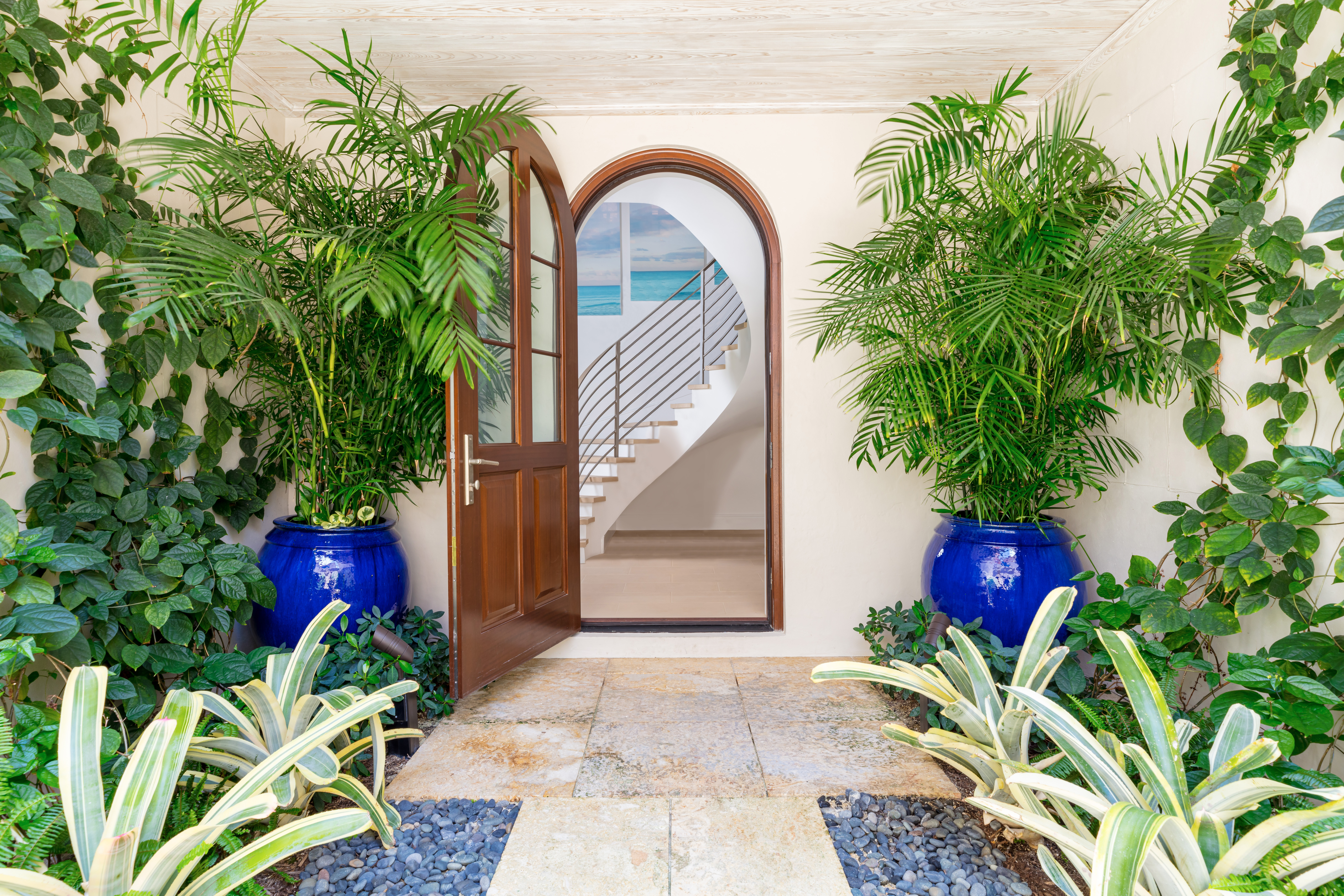 Image of Via Flagler, 5 entry arched door with potted palms