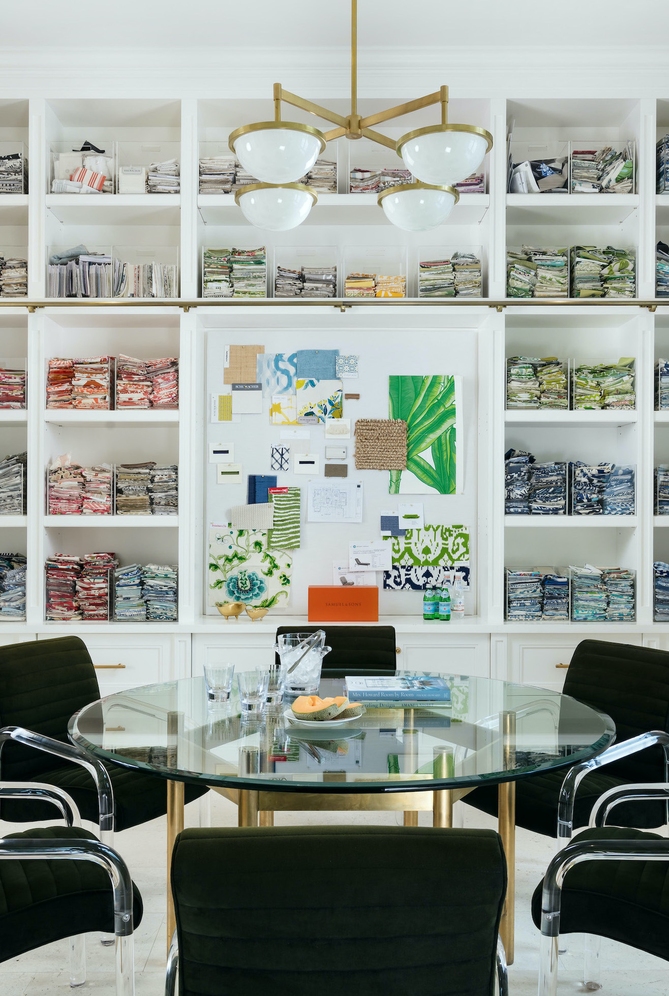 fabric sample library with built in shelves, fabric swatches and round table with chairs