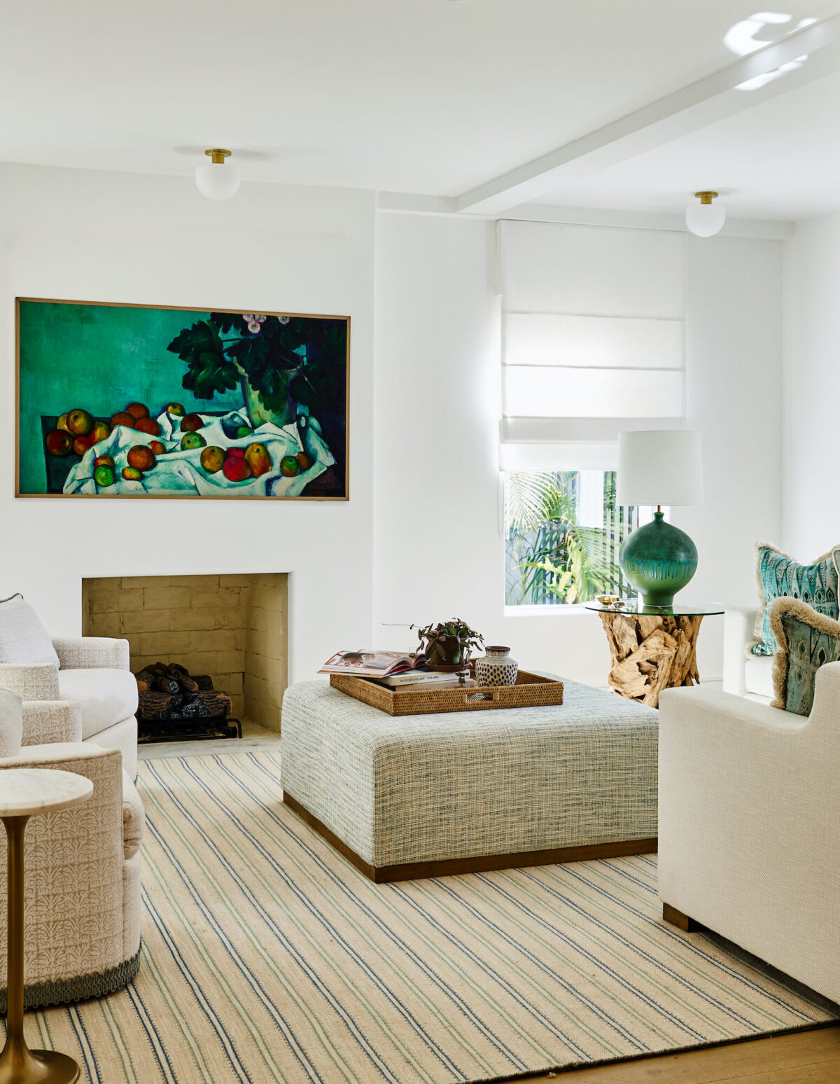 white living room with tv mounted above a fireplace and neutral furniture