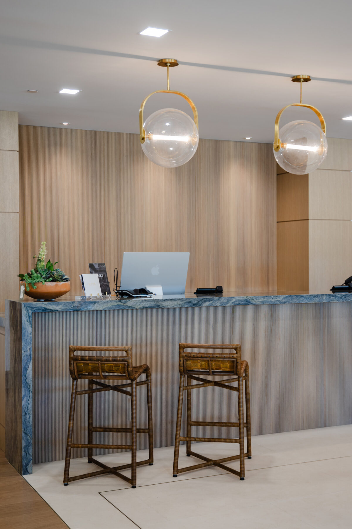Pure by Hive showroom with two bar stools next to the checkout counter and two round pendant lamps